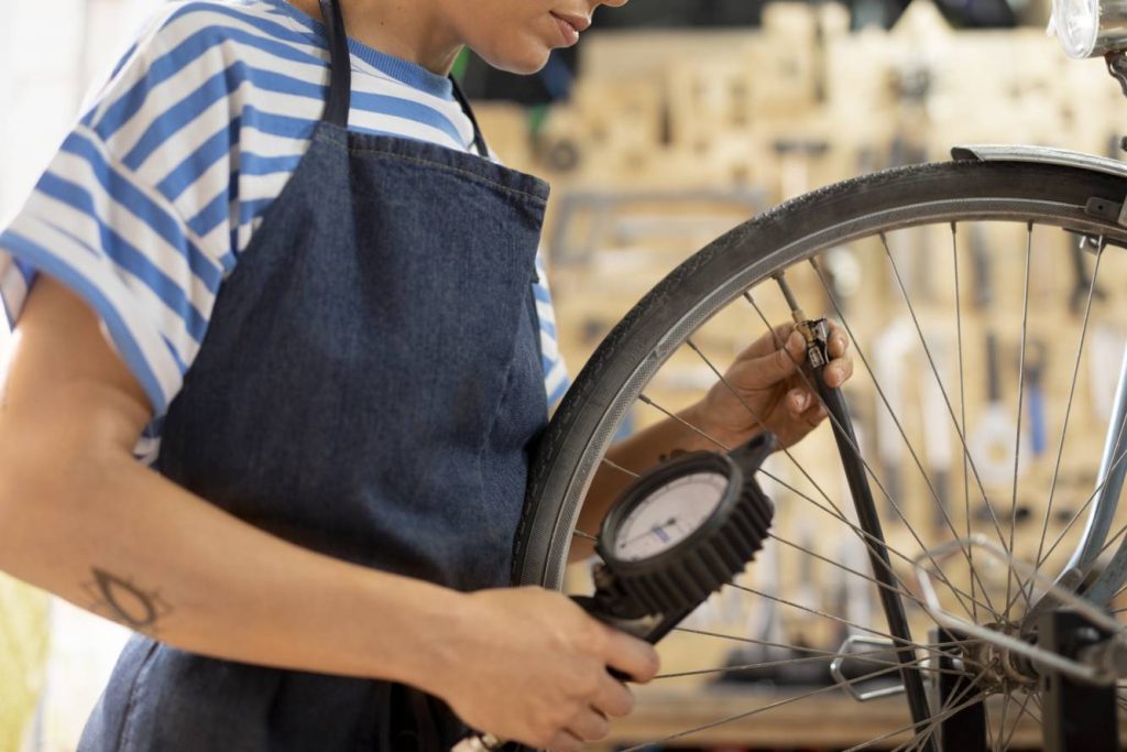 close-up-worker-checking-bike-wheel