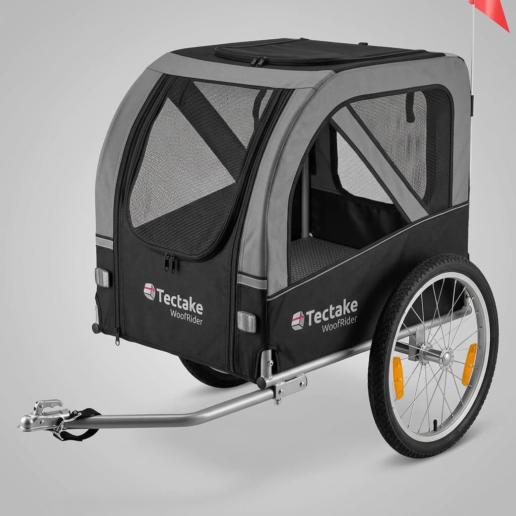 Remorque à vélo Tectake WoofRider pour chien vue de trois-quarts avec fenêtres en maille et revêtement robuste sur fond neutre.